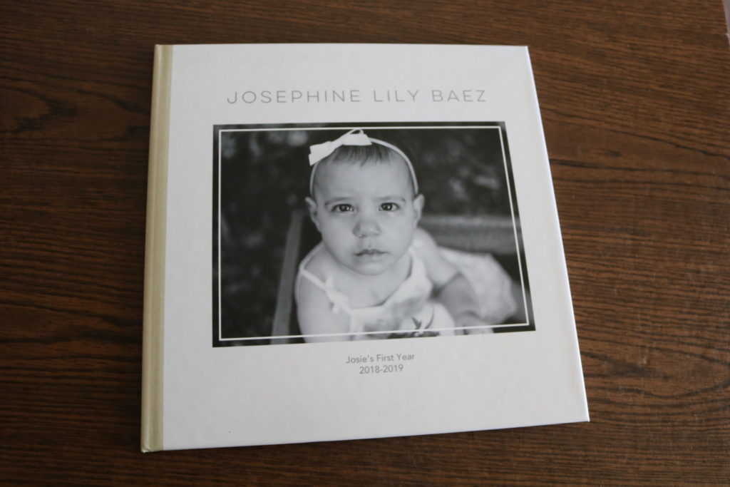 A photo album with a photo of a baby on the cover